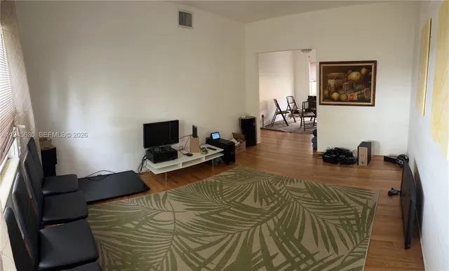 a bedroom with furniture and a flat screen tv