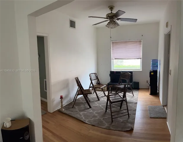 a view of a livingroom with furniture and a window