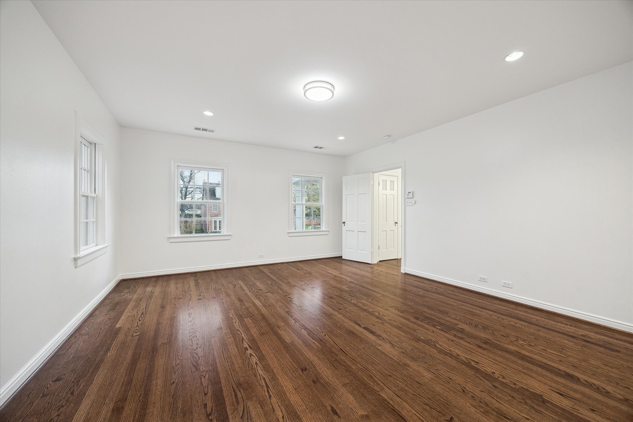2440 Inwood Drive Houston, TX 77019 - Photo 14 of 25 an empty room with wooden floor and windows