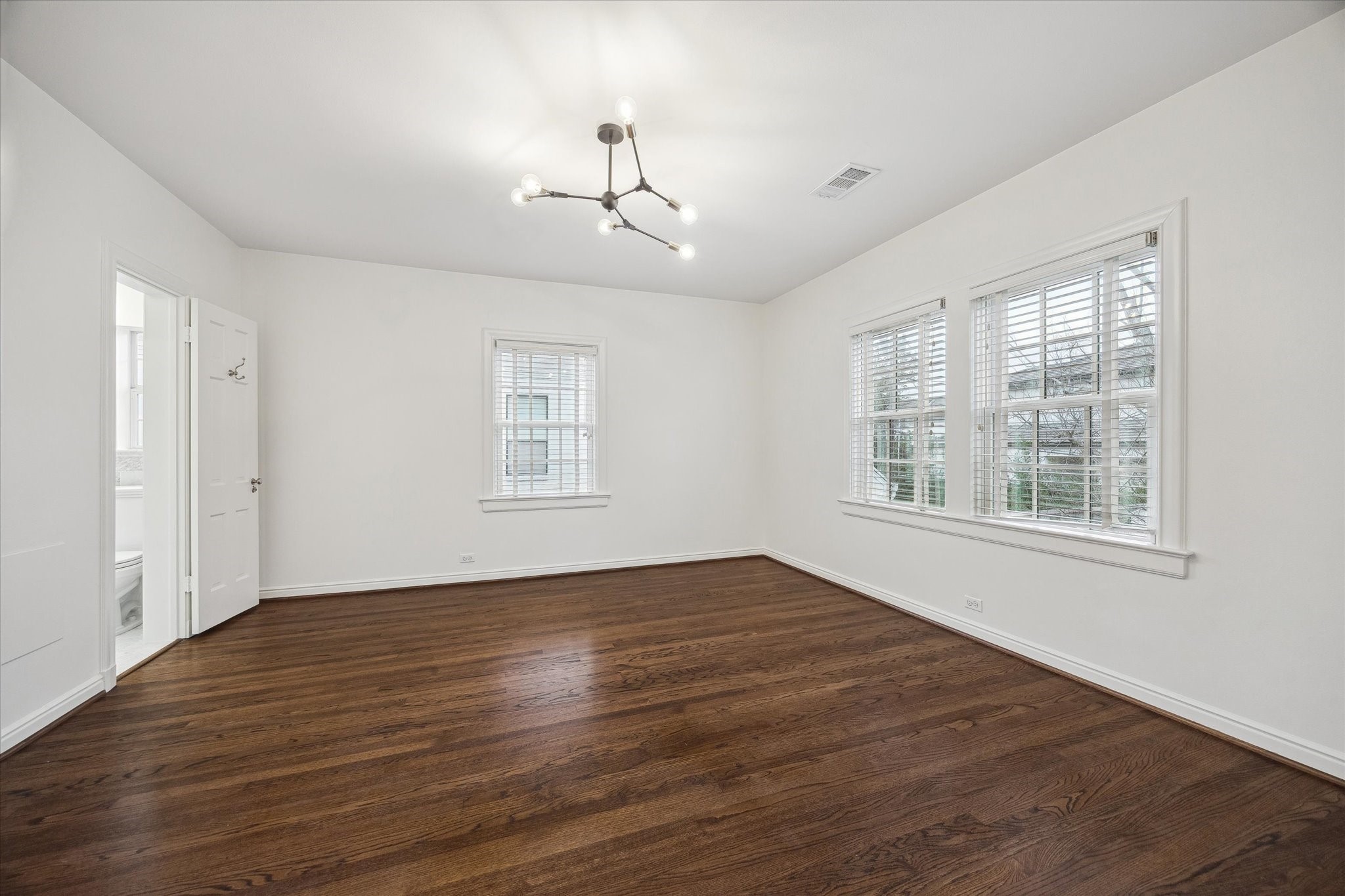 2440 Inwood Drive Houston, TX 77019 - Photo 18 of 25 a view of an empty room with wooden floor and a window