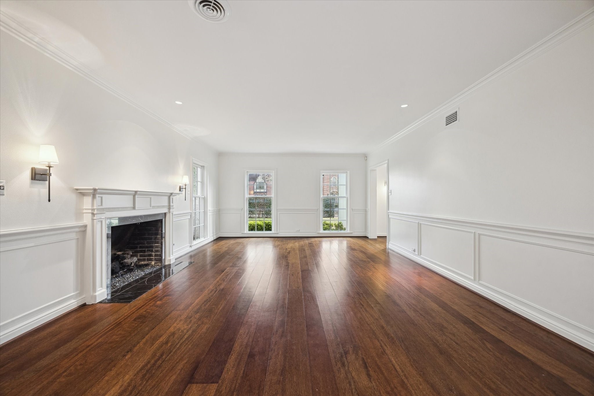 2440 Inwood Drive Houston, TX 77019 - Photo 5 of 25 a view of an empty room with wooden floor fireplace and a window