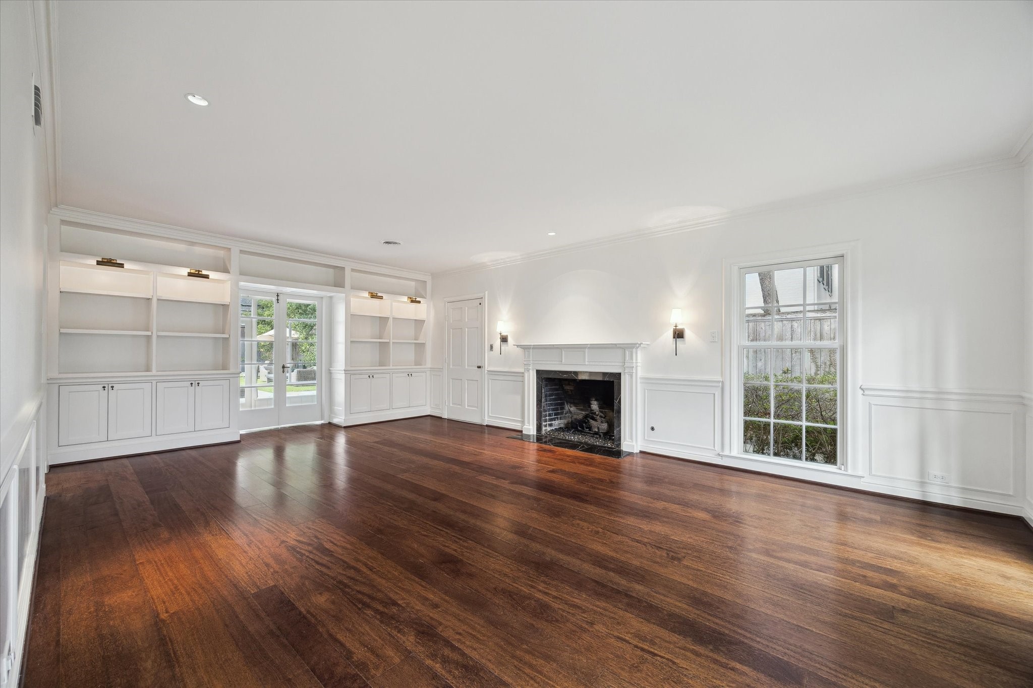 2440 Inwood Drive Houston, TX 77019 - Photo 6 of 25 a view of an empty room with wooden floor and a window