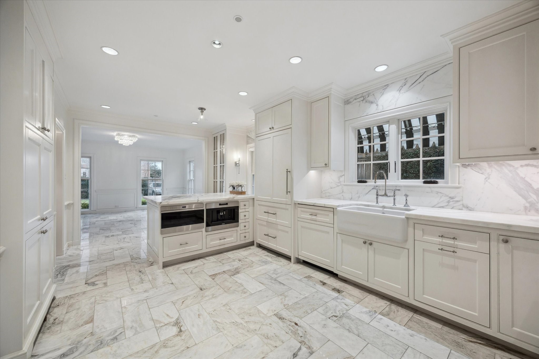 2440 Inwood Drive Houston, TX 77019 - Photo 8 of 25 a large white kitchen with stainless steel appliances kitchen island granite countertop a large counter top and sink