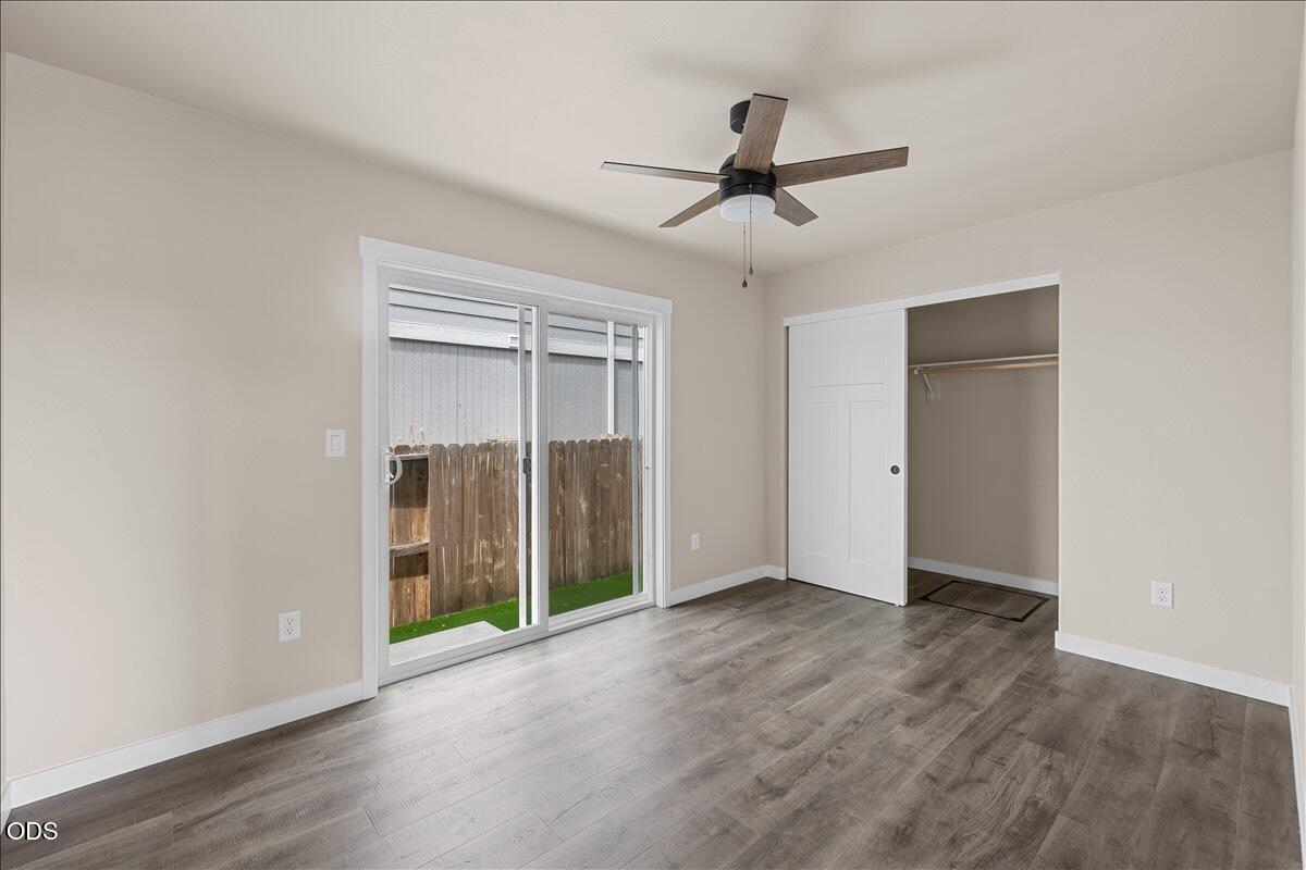 7869 Houston Loop White City, OR 97503 - Photo 6 of 15 a view of an empty room with wooden floor and a ceiling fan