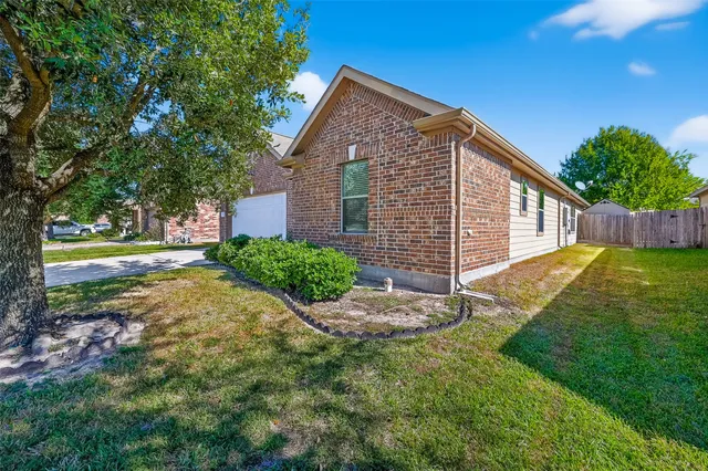 a view of a house with a yard and pathway