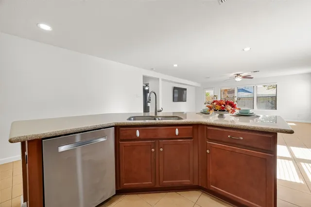 a kitchen with granite countertop a sink and cabinets