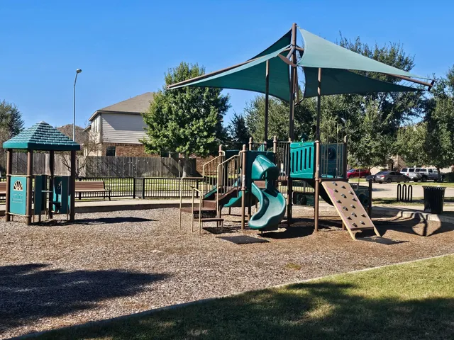 a view of a swimming pool with a yard and sitting area