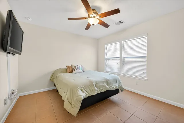 a bed sitting in a bedroom next to a window