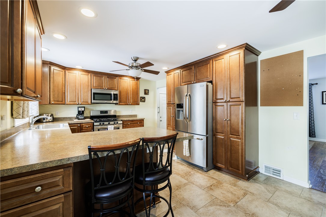3695 Lyell Road Gates, NY 14606 - Photo 7 of 29 No Shortage of Cupboards in this Kitchen!