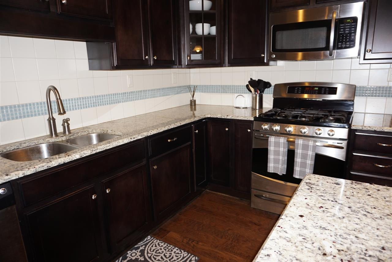 2411 Memory Ridge Drive Raleigh, NC 27606 - Photo 6 of 25 Upgraded gas stove. Custom tile back splash.