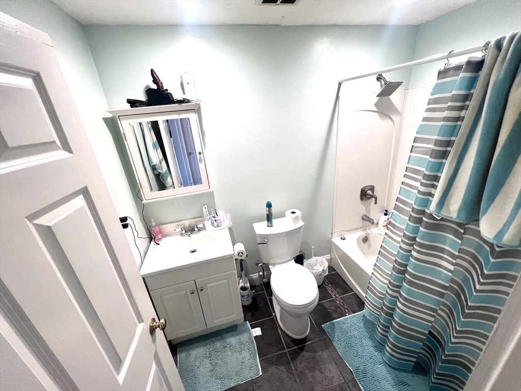 16 Merrimack Street, Unit 4A Lowell, MA 01852 - Photo 14 of 24 a bathroom with sink and mirror