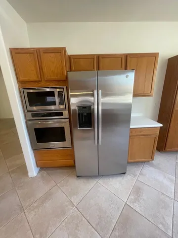 a kitchen with a refrigerator and washing machine