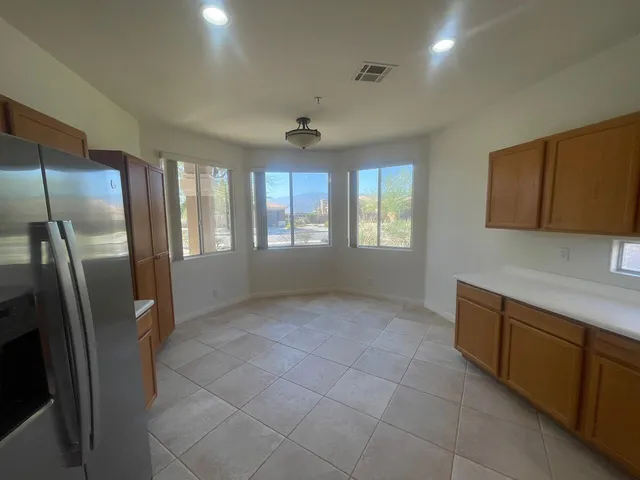 a view of a kitchen with a sink dishwasher and a refrigerator