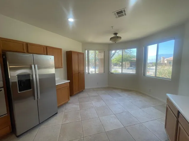 a kitchen with stainless steel appliances a refrigerator and window