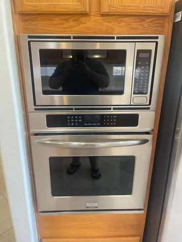 a stove top oven sitting inside of a kitchen