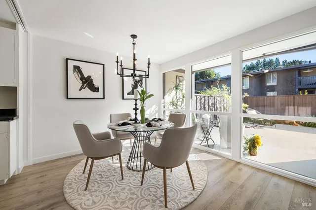 a dining room with furniture and wooden floor