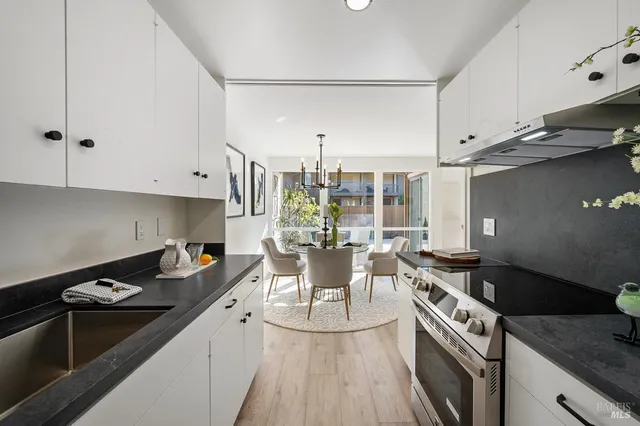 a kitchen with a stove and white cabinets