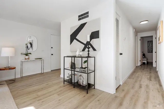 a view of a hallway view with wooden floor and furniture