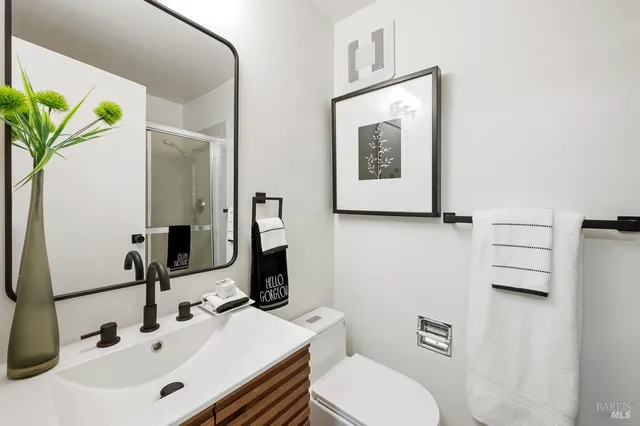 a bathroom with a toilet sink and mirror