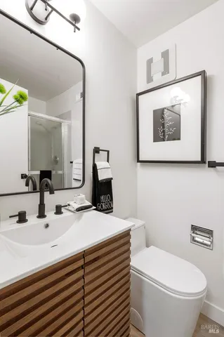 a bathroom with a sink a toilet and mirror