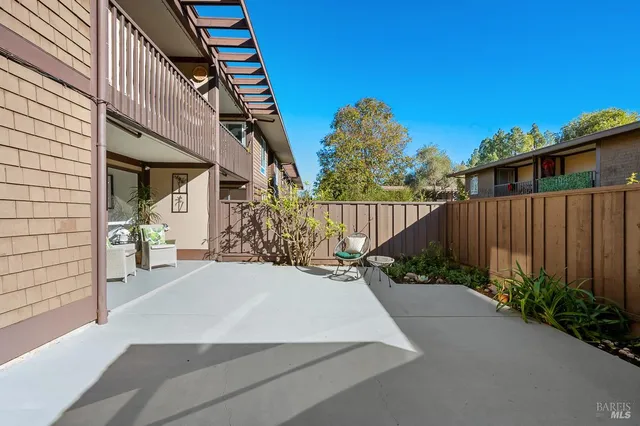 a view of a house with wooden fence