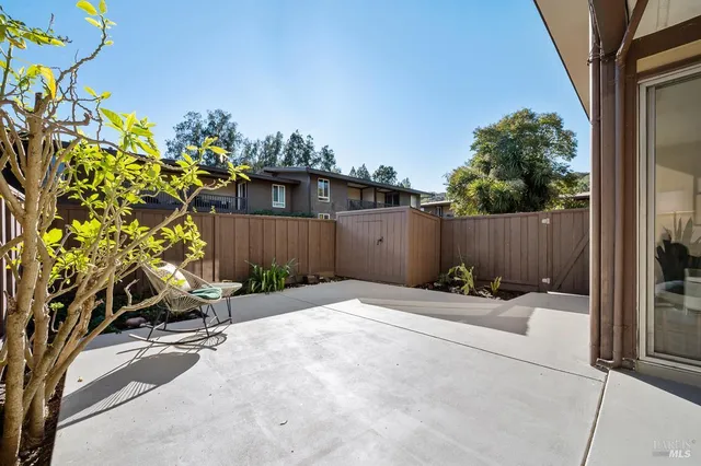 a backyard of a house with table and chairs