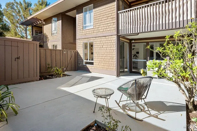 a balcony with table and chairs