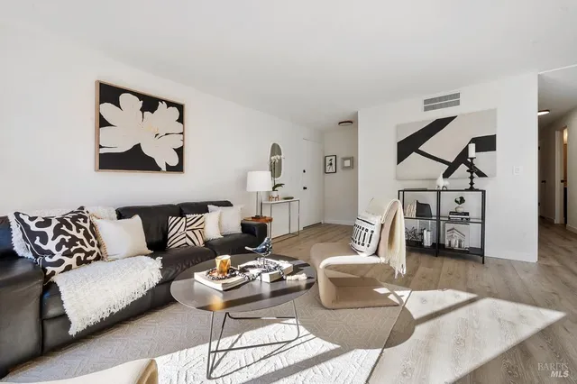 a living room with furniture and wooden floor