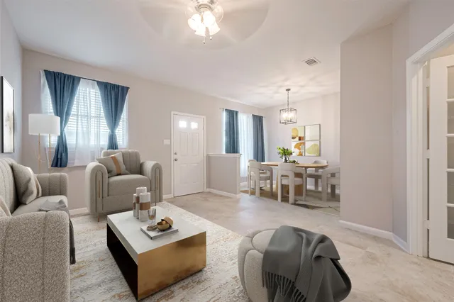 a living room with furniture and a chandelier