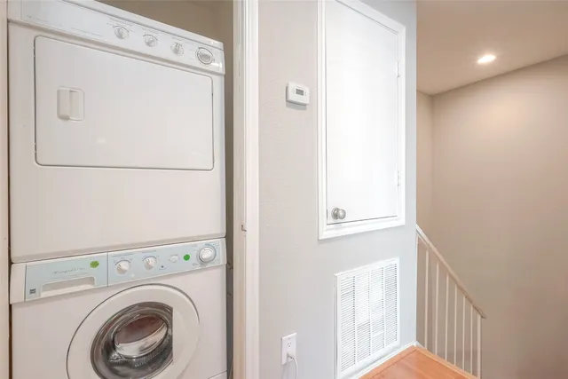 a view of a hallway with washer and dryer