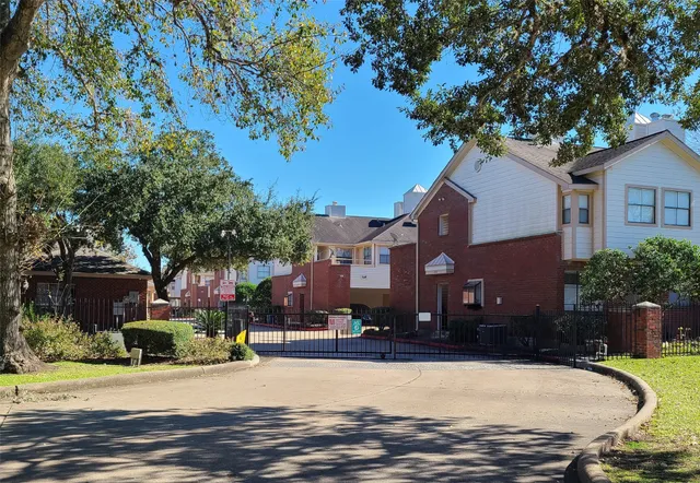 a view of a house with a tree in front of it
