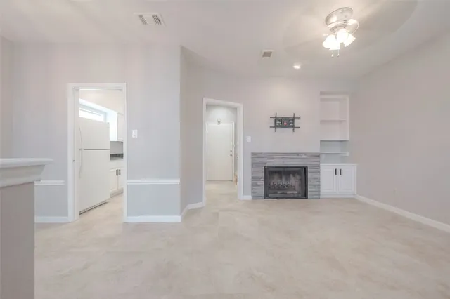 a view of a livingroom with a fireplace and window