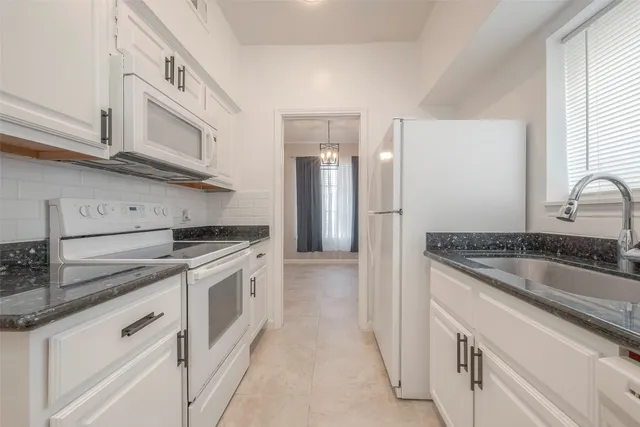 a kitchen with stainless steel appliances granite countertop a sink and a stove