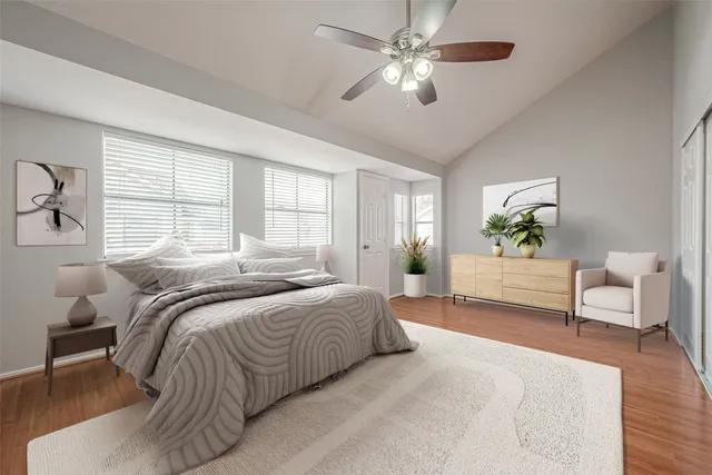 a bedroom with a bed couch and window