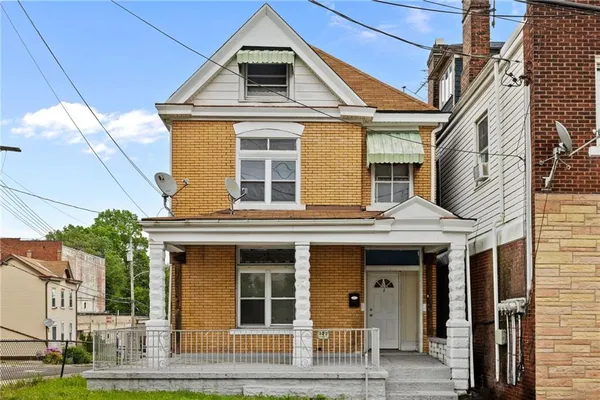 a front view of a house with a yard