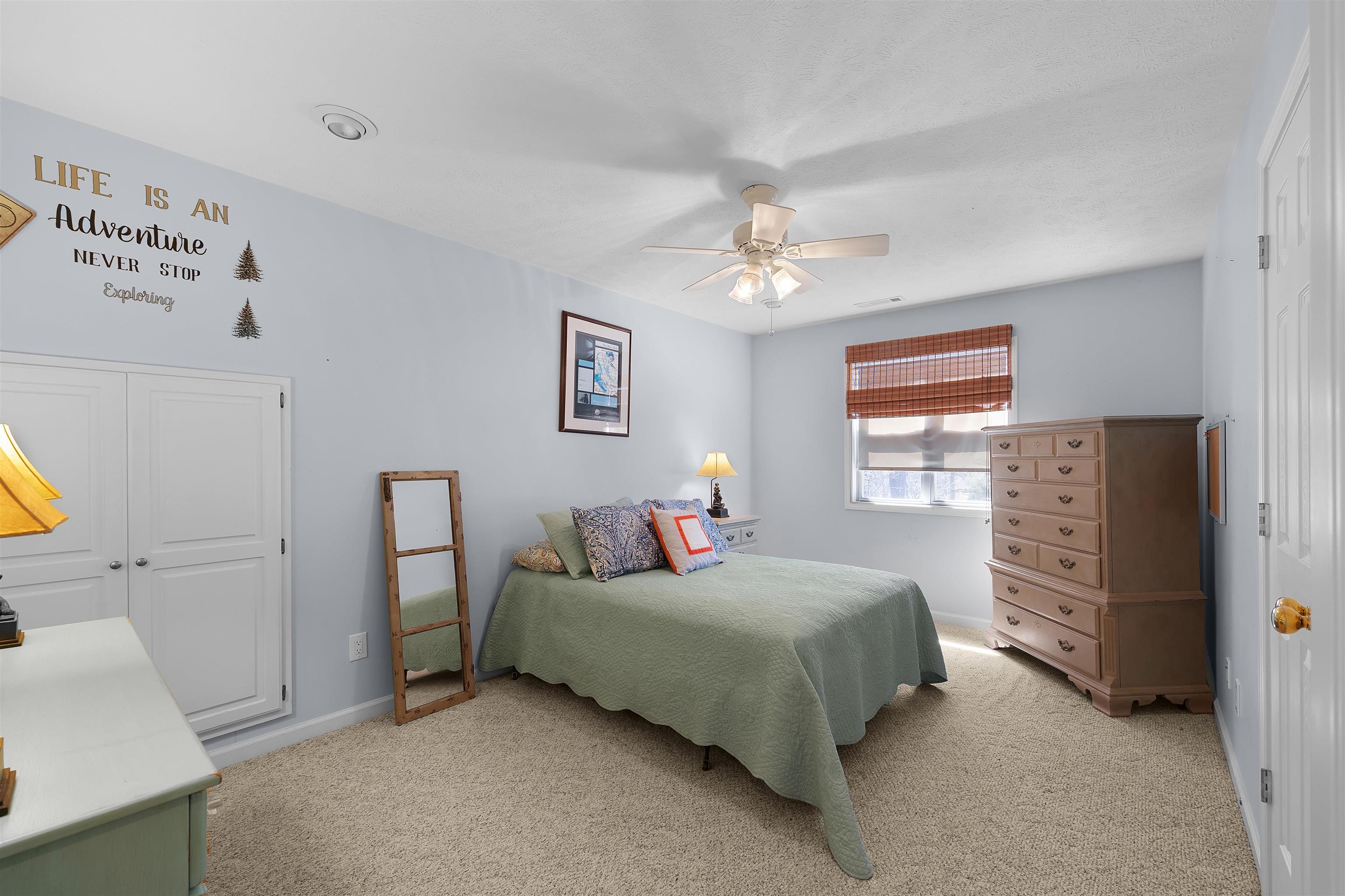 110 Falling Leaf Lane Counce, TN 38326 - Photo 17 of 31 a bedroom with a bed and a chandelier