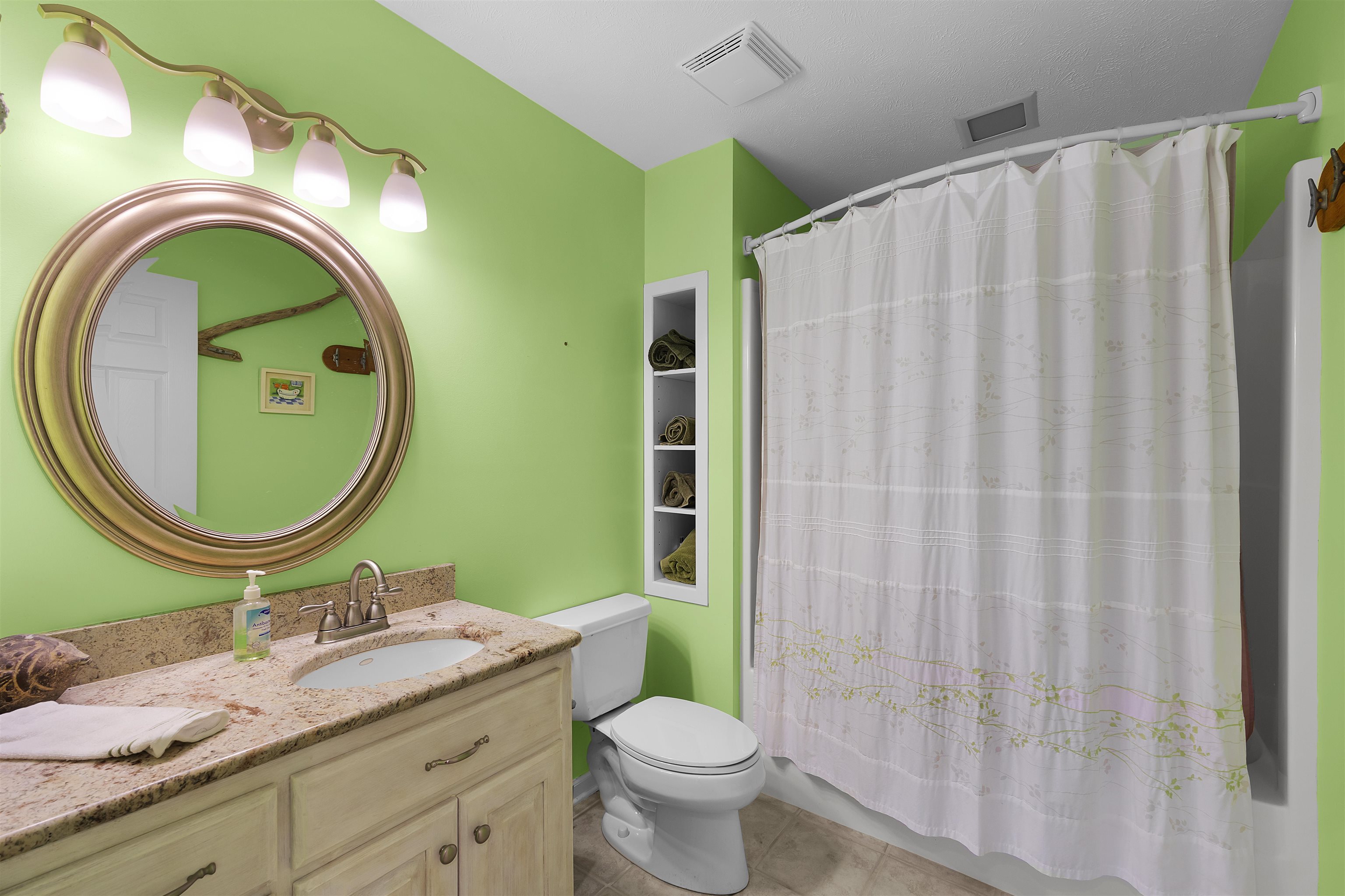 110 Falling Leaf Lane Counce, TN 38326 - Photo 18 of 31 a bathroom with a granite countertop toilet sink and mirror