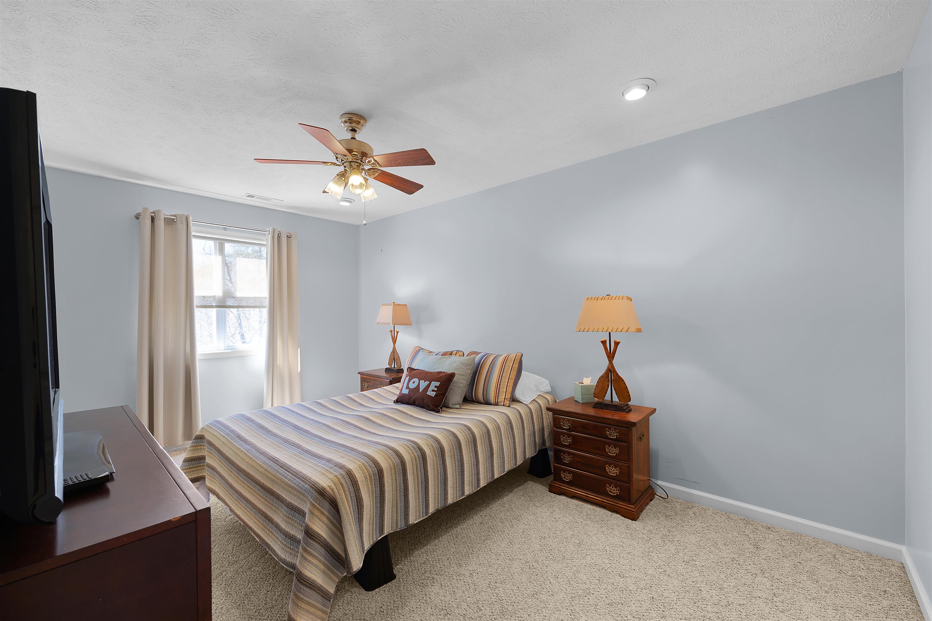 110 Falling Leaf Lane Counce, TN 38326 - Photo 20 of 31 a bedroom with a bed and a chandelier