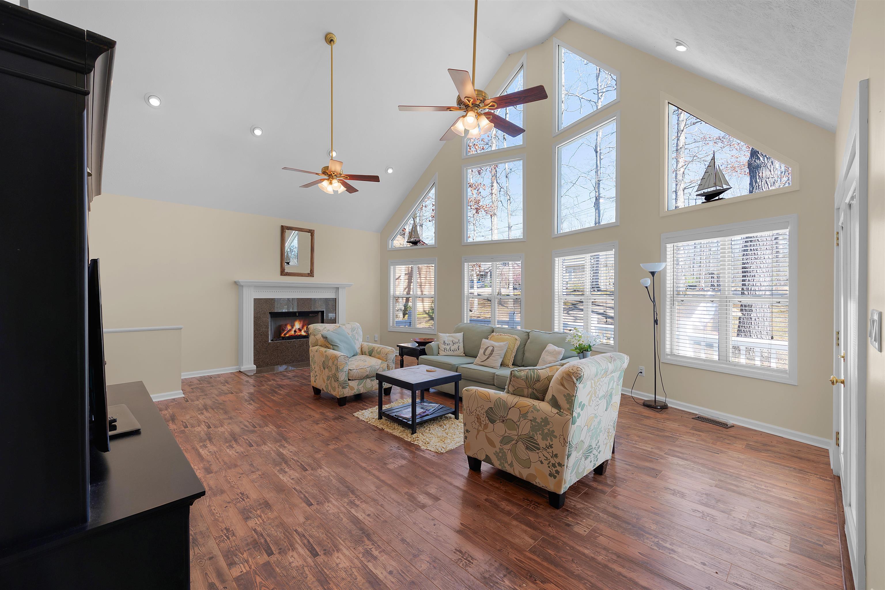 110 Falling Leaf Lane Counce, TN 38326 - Photo 3 of 31 a living room with furniture a fireplace and a floor to ceiling window