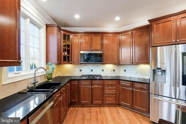 a dining room with furniture a chandelier and wooden floor
