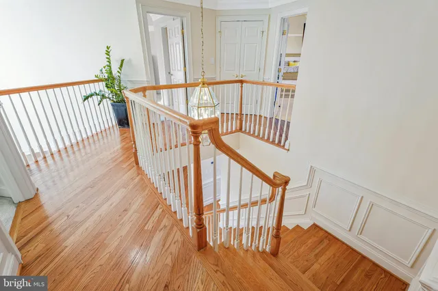 a bedroom with a bed a large mirror and a large window