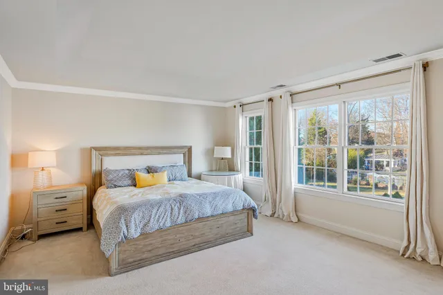 a spacious bathroom with a tub sink and mirror