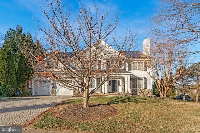 a view of a white house with a snow on the road
