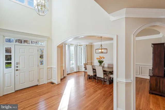 a view of a dining room with furniture wooden floor and chandelier
