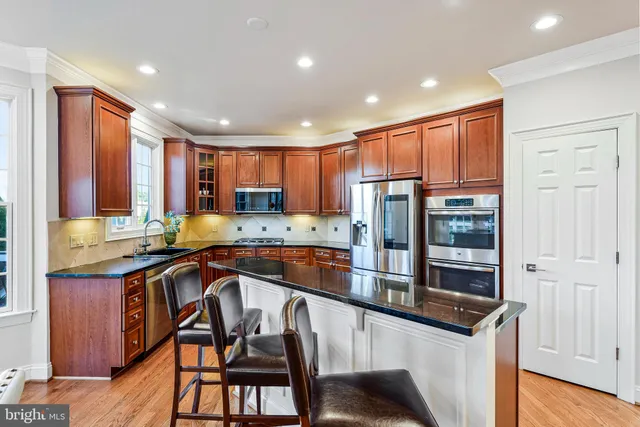 a kitchen with granite countertop a sink and a stove