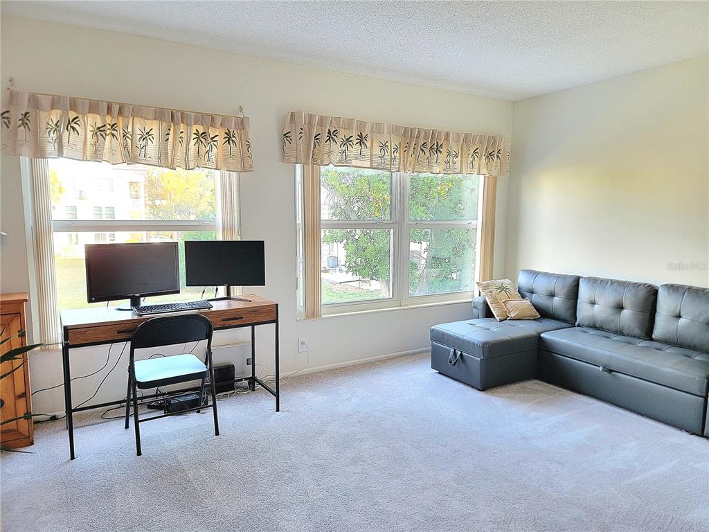 2371 Israeli Drive, Unit 39 Clearwater, FL 33763 - Photo 12 of 34 a view of a livingroom with workspace and a window