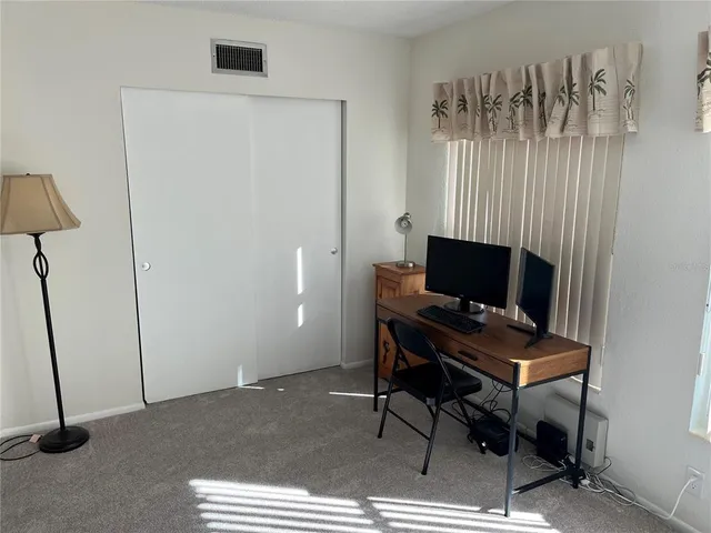 a living room with furniture and a lamp