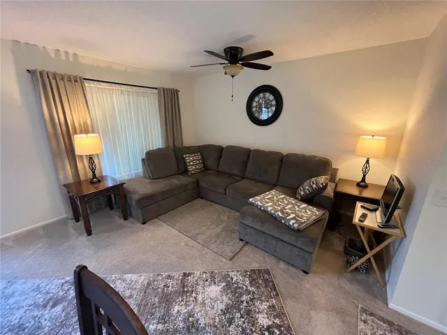 a dining hall with stainless steel appliances kitchen island granite countertop a dining table and chairs