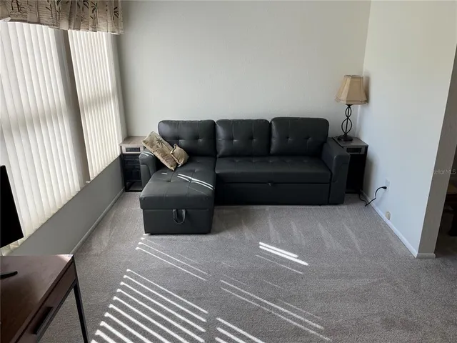 a view of building with river and trees in the background