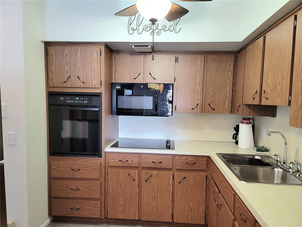 2371 Israeli Drive, Unit 39 Clearwater, FL 33763 - Photo 6 of 34 a kitchen with stainless steel appliances granite countertop a sink and cabinets